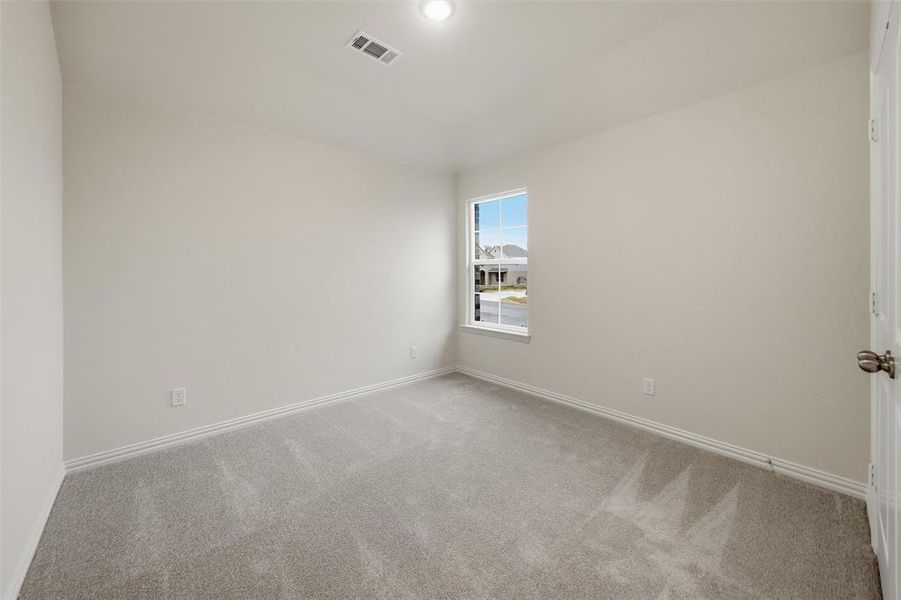 Carpeted spare room with baseboards