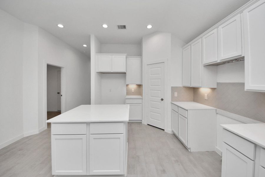 The extended counter area adds both practicality and style, making meal preparation a breeze. Every detail is thoughtfully designed to enhance the kitchen's functionality and aesthetic appeal. Sample photo of completed home with similar floor plan. Actual colors and selections may vary.
