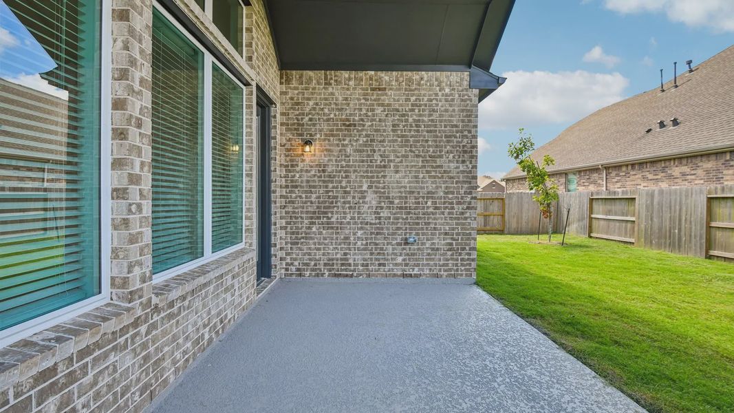 Exterior details and patio area of a home in Artavia, Conroe (Image 26).