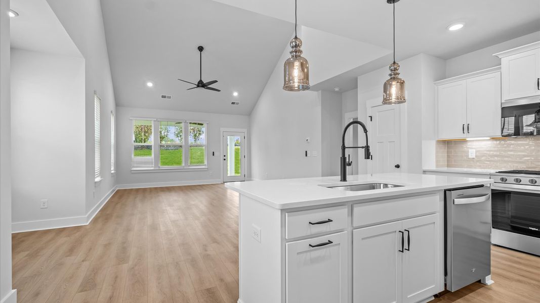 Vibrant kitchen layout with a center island, refined finishes & open-concept flow at Silo Ridge by DRB Homes in Anderson, SC