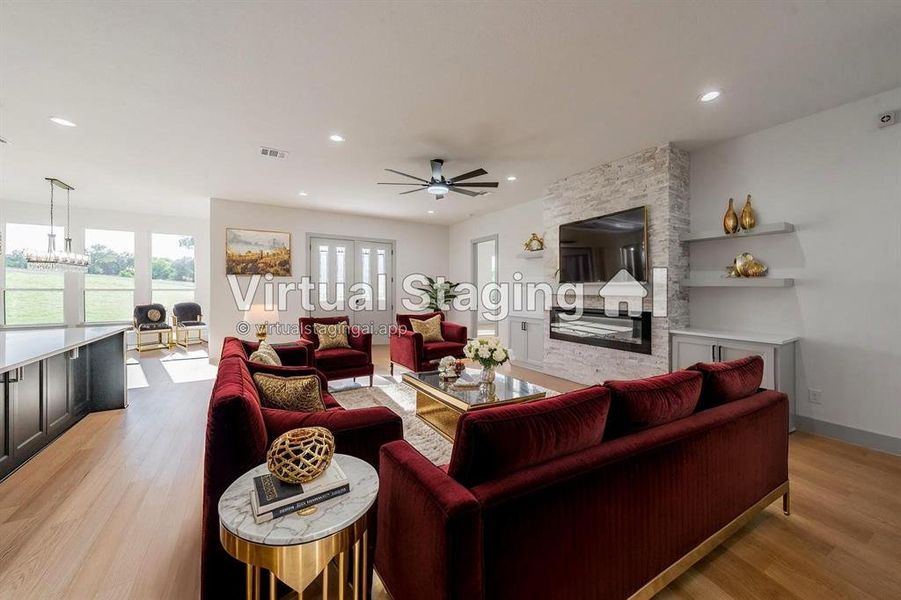 Living area with light wood finished floors, ceiling fan, and recessed lighting