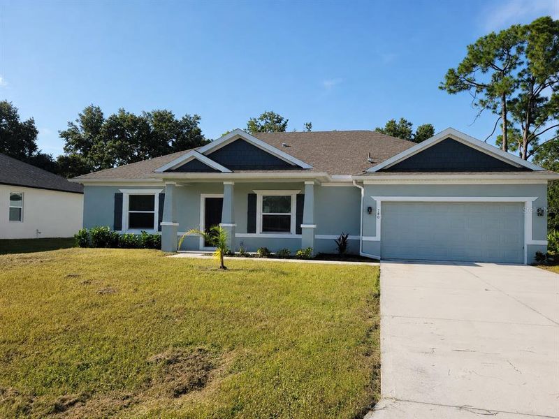 Front exterior of a new home in , Palm Bay, FL, highlighting curb appeal (Image 1). Front exterior of a new home in , Palm Bay, FL, highlighting curb appeal (Image 1).