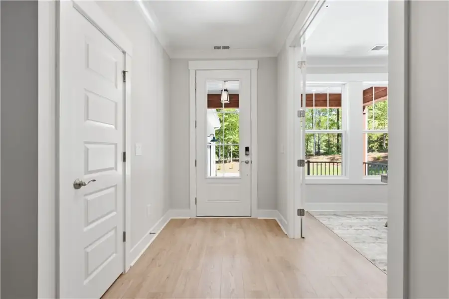 Crisp crown molding accents this inviting entry fe
