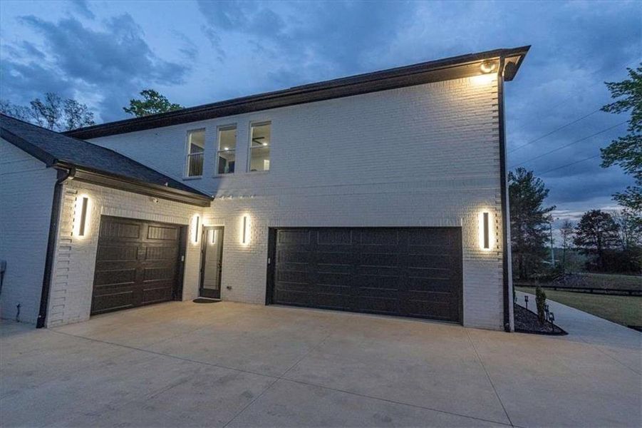 Front exterior of a new home in , Hoschton, GA, highlighting curb appeal (Image 23).