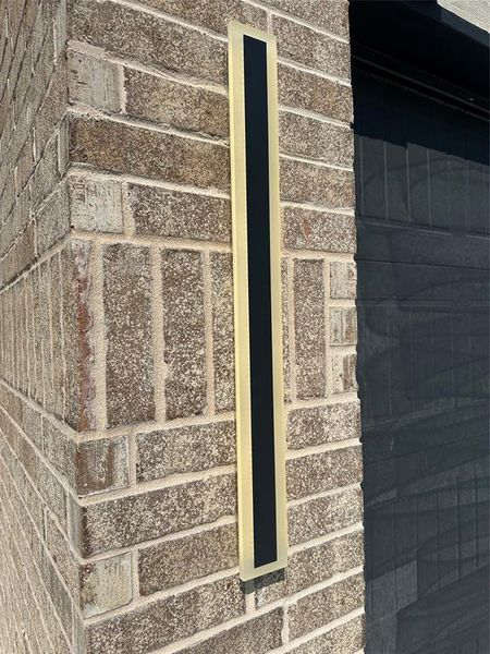 Linear outside lighting flanking garage door