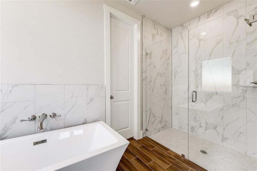 Soaking tub and oversized shower.