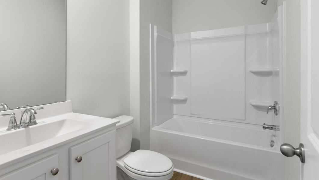 Representative furnished interior of a home built from the WOODSTOCK by D.R. Horton in Surfside Landing, Hubert (Image 10).