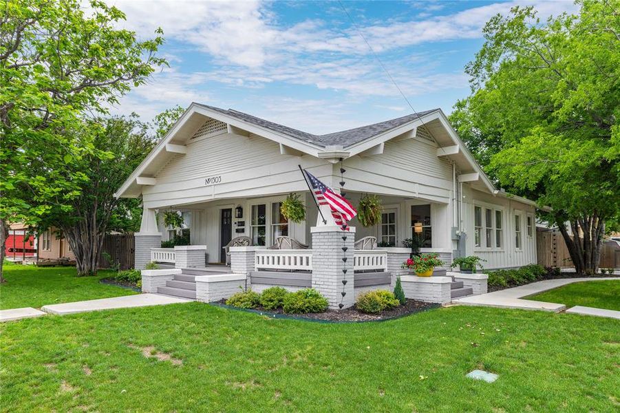 Craftsman-style residence featuring white siding and a covered front porch