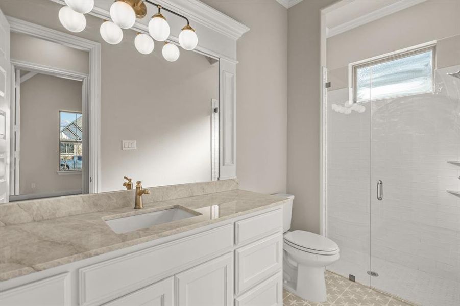 Bathroom with vanity, toilet, and a shower with door