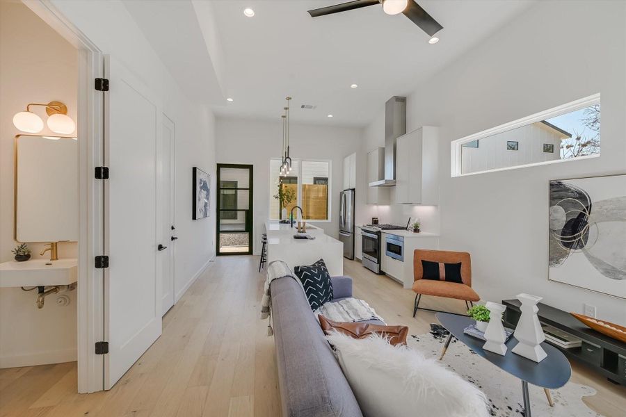 Living room featuring sink, a wealth of natural light, and light hardwood / wood-style floors