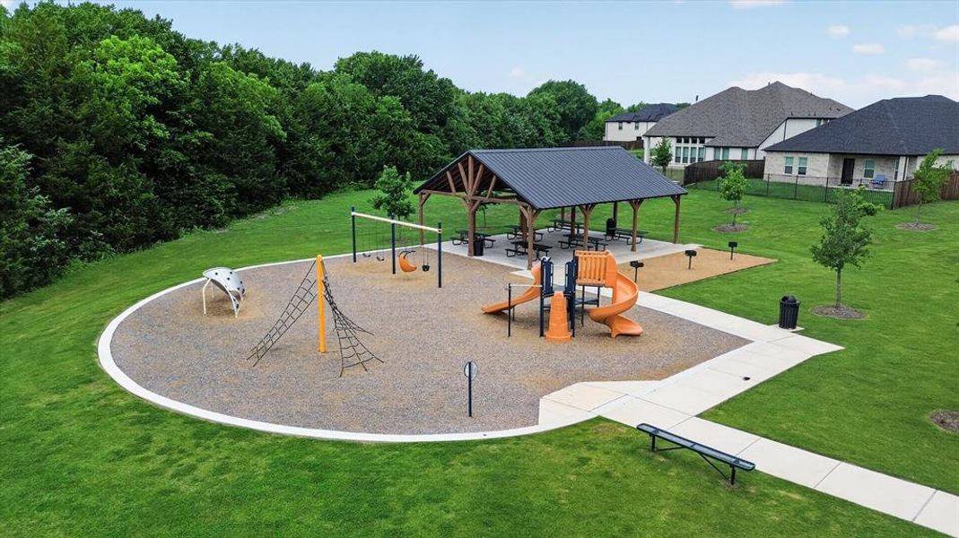Community playground area featuring multiple slides, swings, and climbing structures