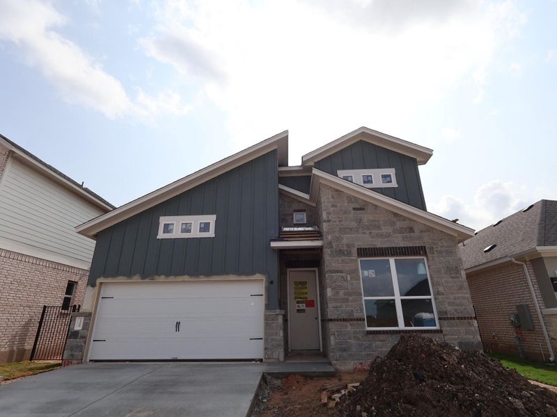 Front exterior of a new home in Estancia West, Manchaca, TX, highlighting curb appeal (Image 1). Front exterior of a new home in Estancia West, Manchaca, TX, highlighting curb appeal (Image 1).
