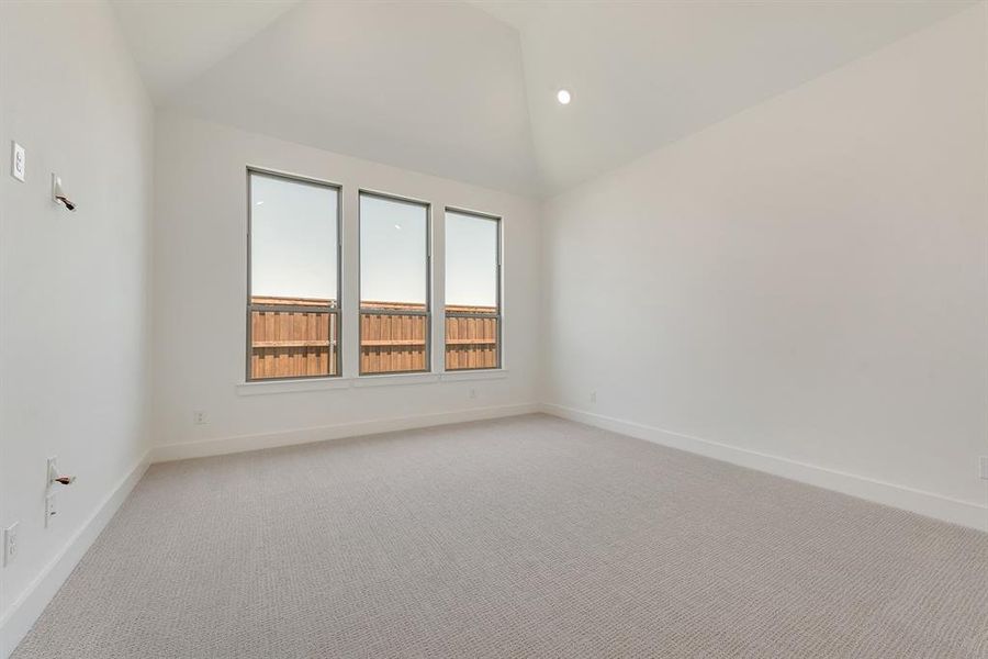 Unfurnished room featuring light colored carpet, recessed lighting, and high vaulted ceiling Unfurnished room featuring light colored carpet, recessed lighting, and high vaulted ceiling