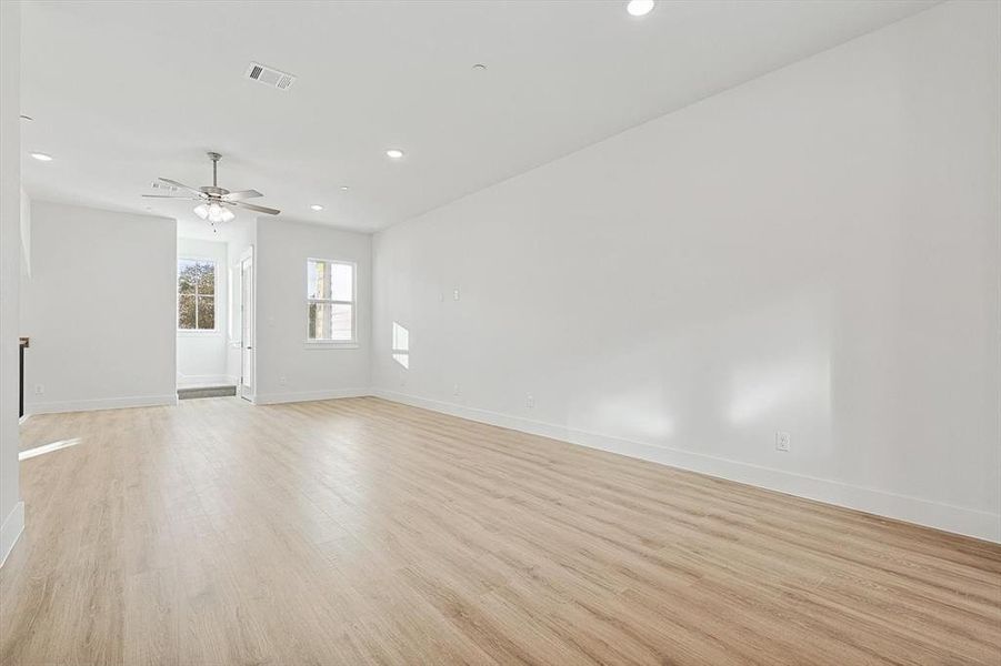 Spare room with visible vents, baseboards, recessed lighting, light wood-style floors, and a ceiling fan