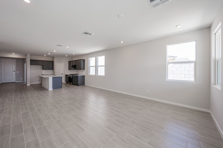 A large empty room with a wood floor and white walls.