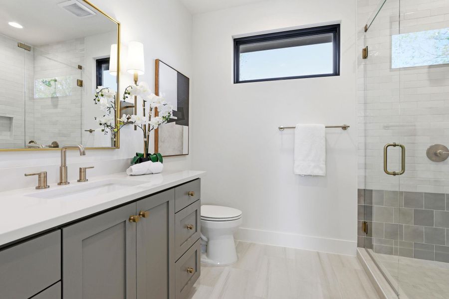 Bathroom with a shower stall and vanity Bathroom with a shower stall and vanity