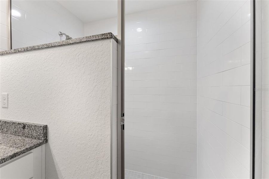 Walk in shower with tiled walls