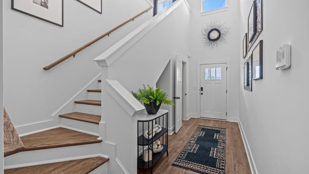 Superior design begins at the front door with a hardwood floor foyer and elegant sightlines at Barton Hollow