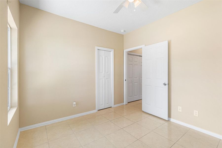 Bedroom 1 with walk-in closet and ceiling fan Bedroom 1 with walk-in closet and ceiling fan