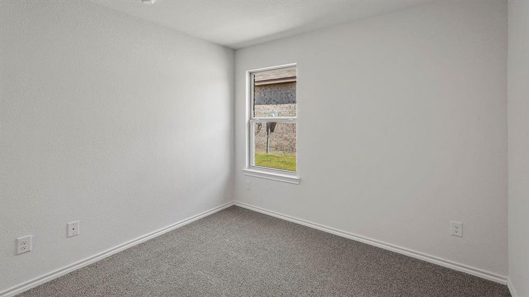 Neutral-toned walls and grey carpeting create a versatile interior