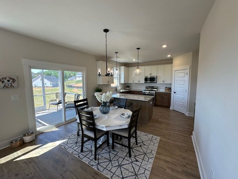 This bright kitchen and dining area features moder