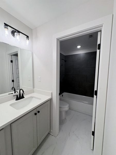 Vanity with white countertop, undermount sink, and matte black faucet Vanity with white countertop, undermount sink, and matte black faucet