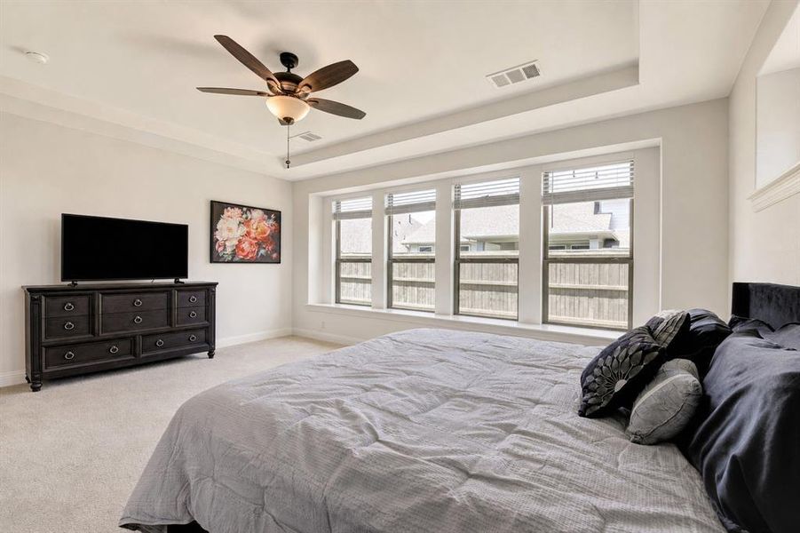 The spacious first-floor owner's suite includes a sitting area with backyard views.