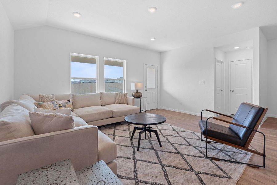 Living area with light wood-style floors and recessed lighting Living area with light wood-style floors and recessed lighting