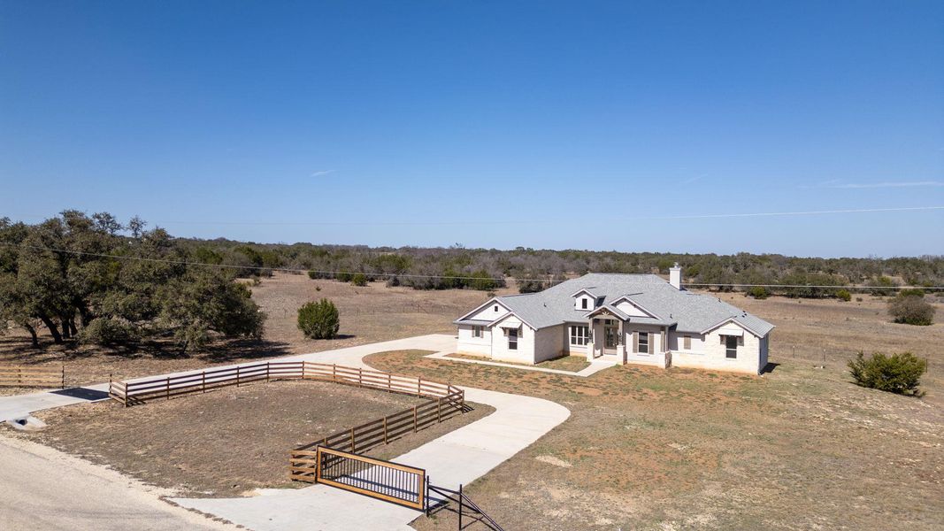 View of front facade featuring a rural view and a gate