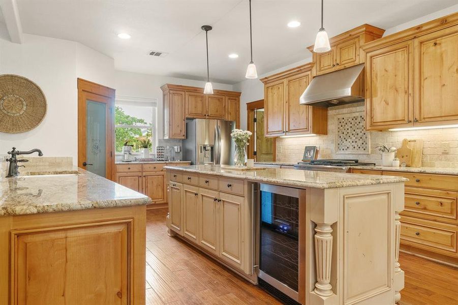 Kitchen in home number two features separate beverage fridge and custom wooden cabinets.