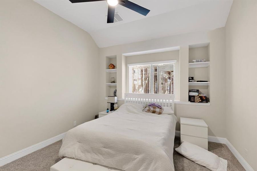 Bedroom with carpet flooring, ceiling fan, and vaulted ceiling Bedroom with carpet flooring, ceiling fan, and vaulted ceiling