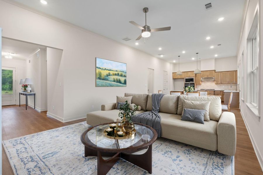 Open concept living area featuring wood-finish flooring, recessed lighting, and a ceiling fan Open concept living area featuring wood-finish flooring, recessed lighting, and a ceiling fan