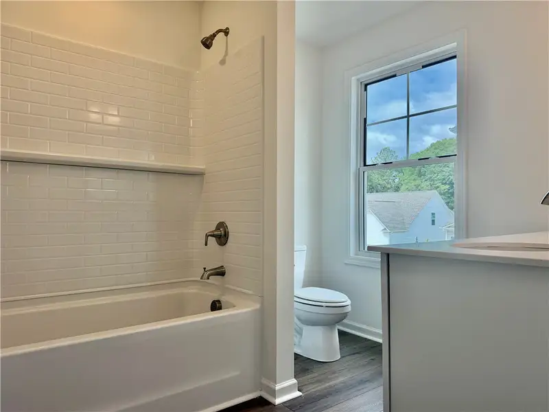 A modern bathroom features classic subway tile sur