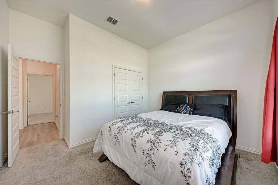 Comfortable carpeting and a spacious closet create a tranquil bedroom retreat.