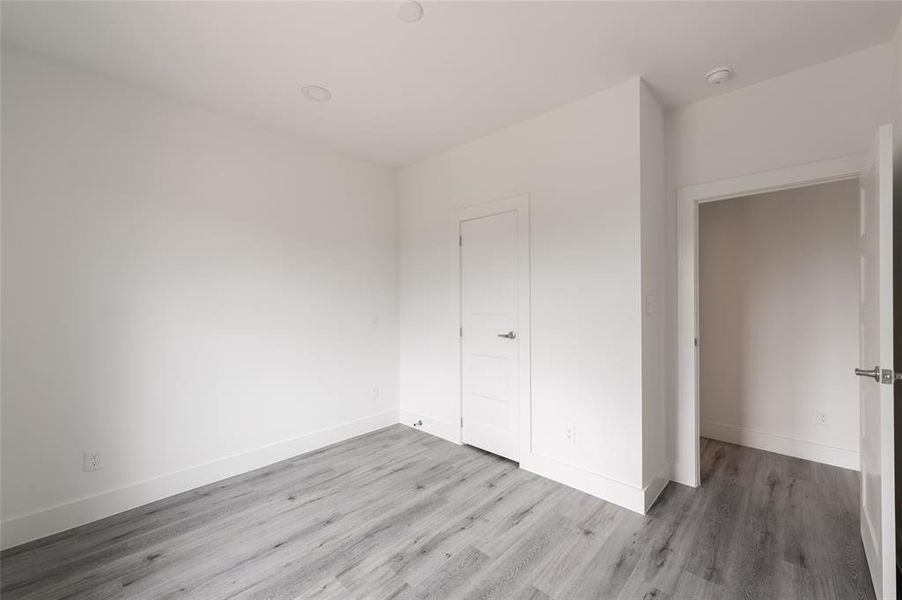 *Representative Photo.This is a bright, clean room with neutral walls and modern gray wood flooring.