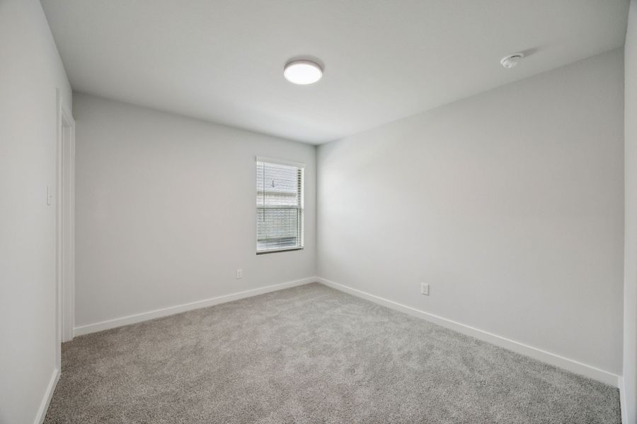 Bedroom in the Hadley home plan by Trophy Signature Homes – REPRESENTATIVE PHOTO