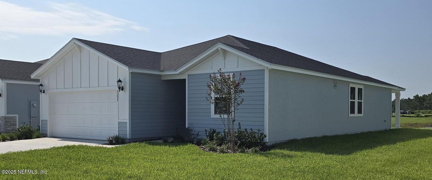 Front exterior of a new home in Lakes at Bella Lago - Signature Series, Green Cove Springs, FL, highlighting curb appeal (Image 17).