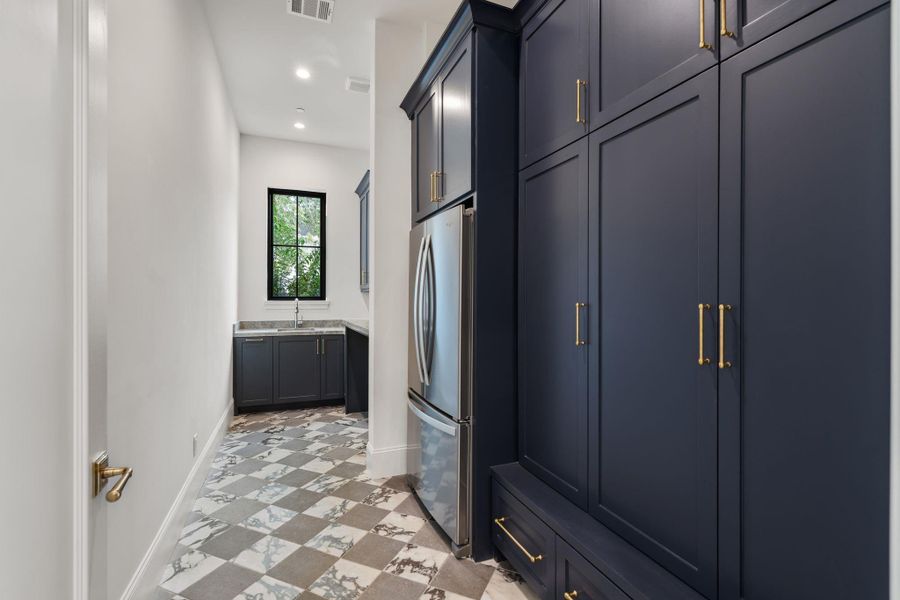 The laundry has oversized built ins for sports equipment, backpacks, also contains charging plugs in each unit.