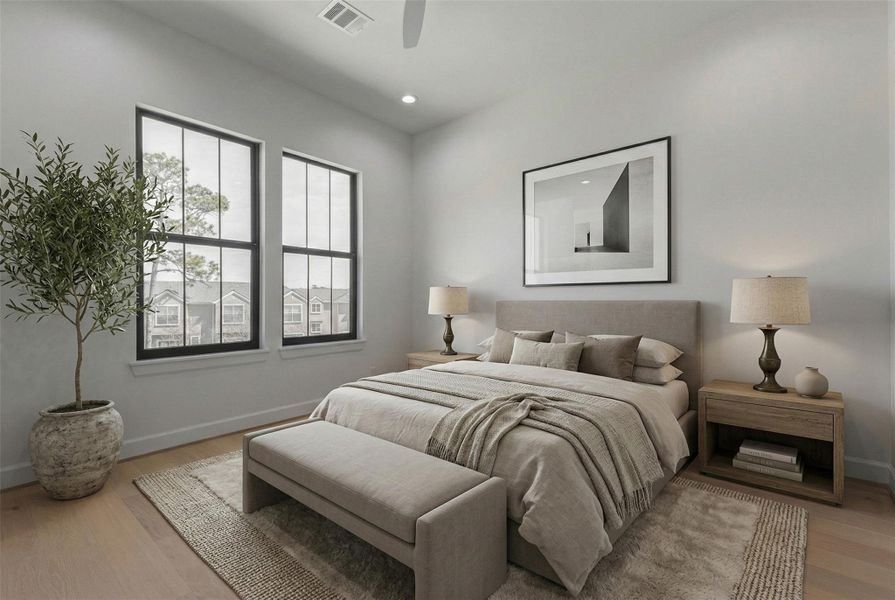 Light-filled secondary bedroom with wide-plank engineered wood flooring, tall black-framed windows, recessed lighting, and ceiling fan. Located on the upper level, this spacious room offers flexibility for guest accommodations, family living, or a home office while reflecting the home’s clean contemporary aesthetic.