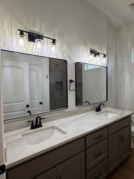 Full bath featuring double vanity