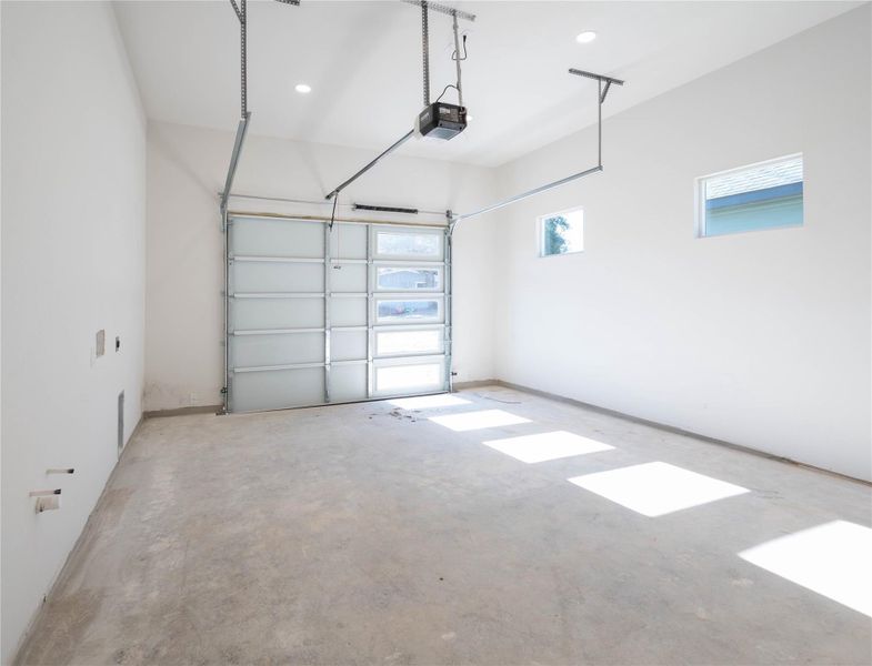 Garage featuring recessed lighting and a garage door opener