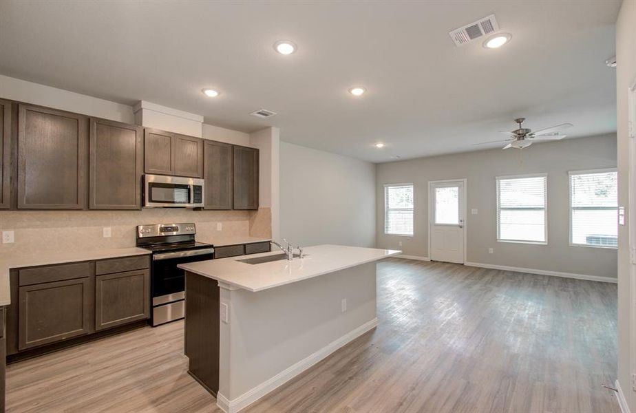 Open concept kitchen/dining living area located on first floor