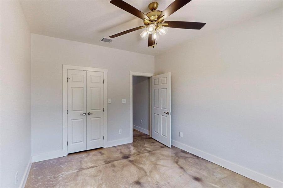 Unfurnished bedroom featuring ceiling fan and a closet