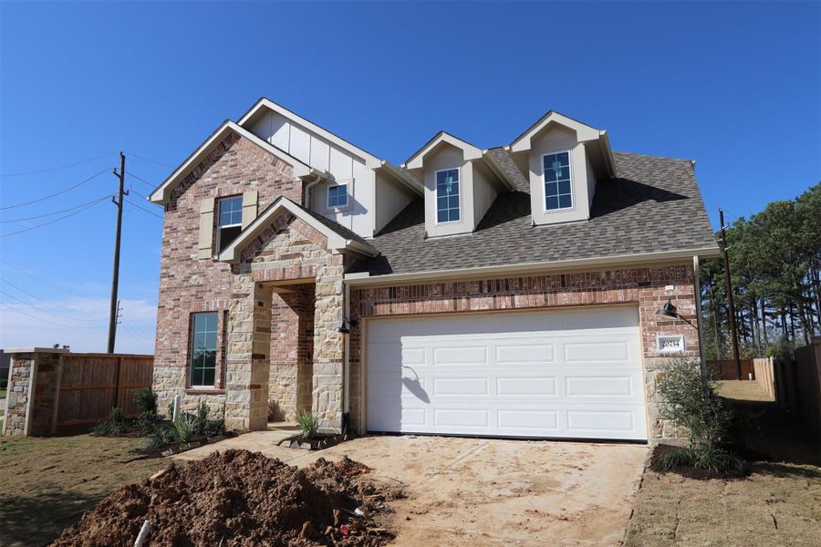 Front exterior of a new home in Sorella, Tomball, TX, highlighting curb appeal (Image 2). Front exterior of a new home in Sorella, Tomball, TX, highlighting curb appeal (Image 2).