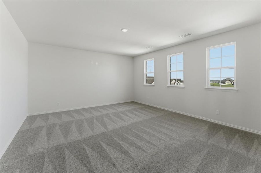 Spare room featuring light carpet and baseboards Spare room featuring light carpet and baseboards