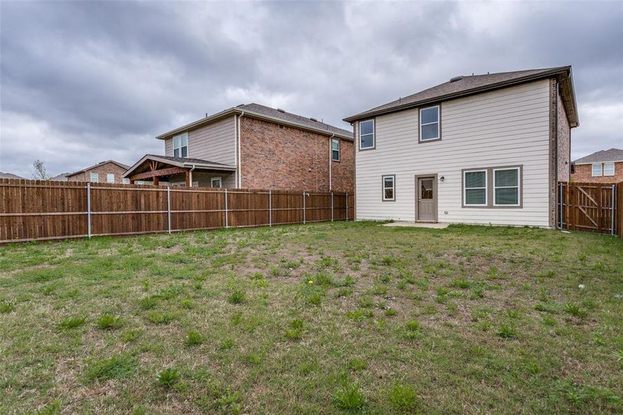 Rear view of house featuring a yard