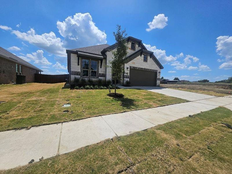 Front exterior of a new home in The Hollow, Ennis, TX, highlighting curb appeal (Image 2). Front exterior of a new home in The Hollow, Ennis, TX, highlighting curb appeal (Image 2).
