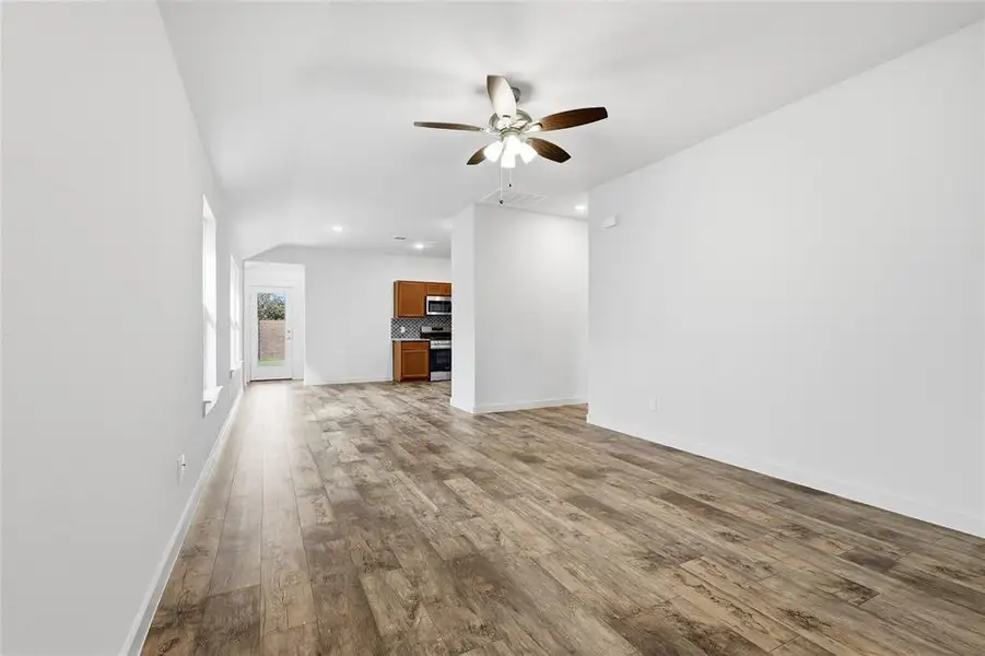 Unfurnished living room featuring hardwood / wood-style flooring, recessed lighting, and ceiling fan Unfurnished living room featuring hardwood / wood-style flooring, recessed lighting, and ceiling fan