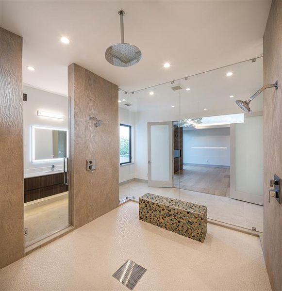 Walk-in shower with double entry and oversized custom-built shower seat with stunning tile details