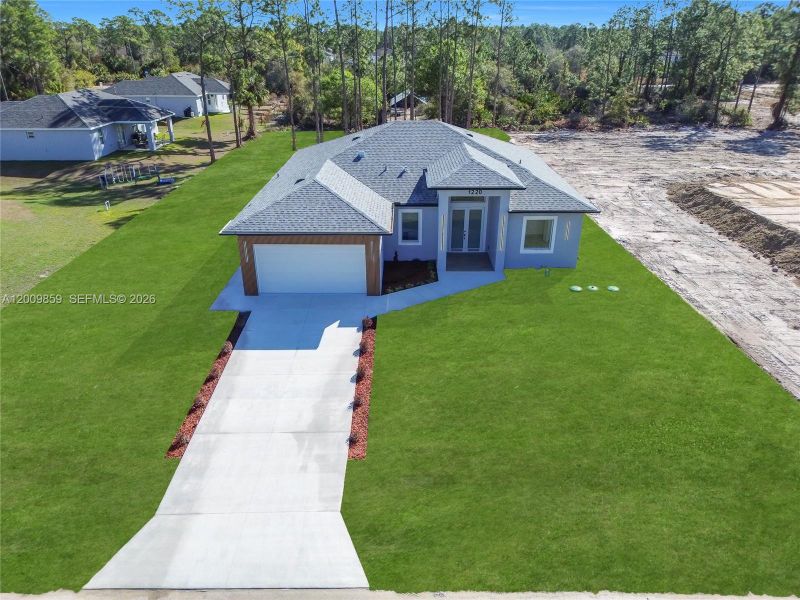 Front exterior of a new home in , Lehigh Acres, FL, highlighting curb appeal (Image 14).